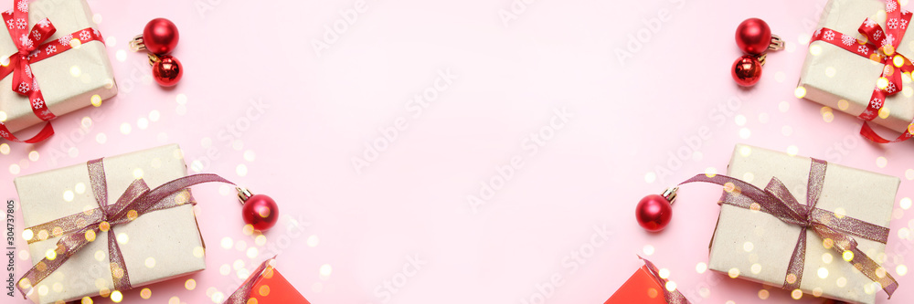 Creative christmas background with beautiful gifts boxes, golden shiny ribbons and red balls on pink background. Top view with copy space. Creative christmas background with beautiful gifts boxes, golden shiny ribbons and red balls on pink background. Top view with copy space.