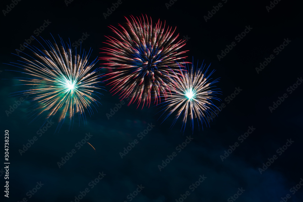 Abstract and brightly colorful firework in the celebration and anniversary festival.Merry Christmas and New year party light over night sky.