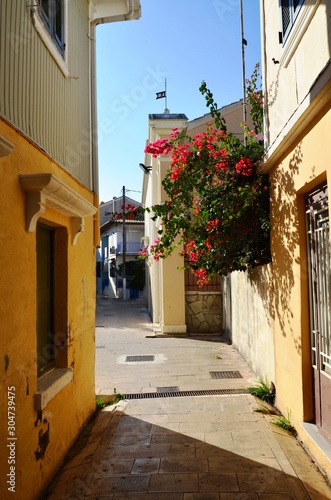Lefkada  Lefkada Island  Greece. 10 22 2019. narrow streets  old houses  windows  doors  balconies  green plants  bright flowers in a European town on the island. cityscape  street without people