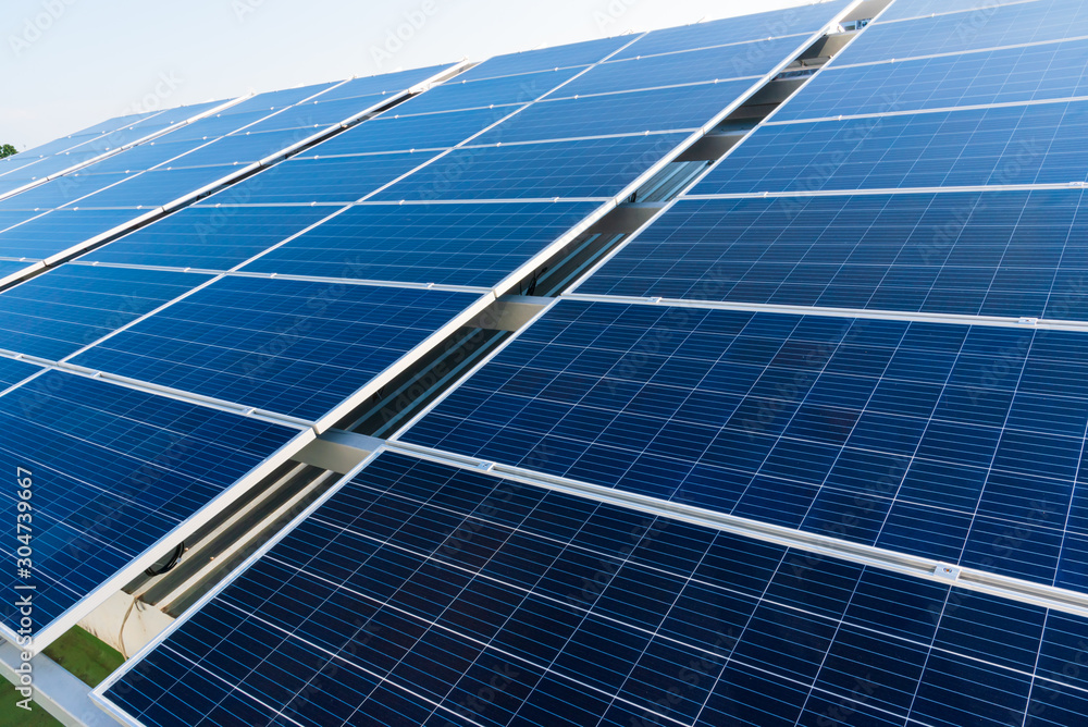 Solar panels and blue sky background.Solar cells farm on the roof.Photovoltaic modules for renewable energy.Save the earth and the energy with good environment concept. Solar panels and blue sky background.Solar cells farm on the roof.Photovoltaic modules for renewable energy.Save the earth and the energy with good environment concept.
