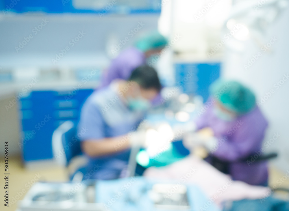 Blurred dentist and assistant examining patient tooth on dental chair at dental department.Medical mouth and tooth health care concept. Blurred dentist and assistant examining patient tooth on dental chair at dental department.Medical mouth and tooth health care concept.