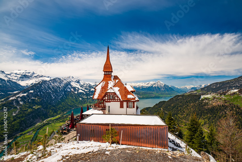 Stunning scenery with mountain hut on top Harder Kulm summit - popular tourist attraction over Interlaken, Switzerland