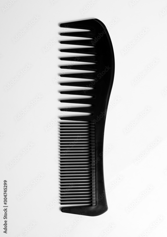 Black comb on white background.Hairdressing accessories Black comb on white background.Hairdressing accessories