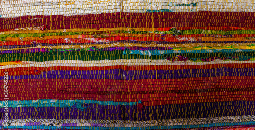 Close up of beautiful colorful hand made motley rug or carpet. Colourful, handmade rugs hanging on display at market, France.