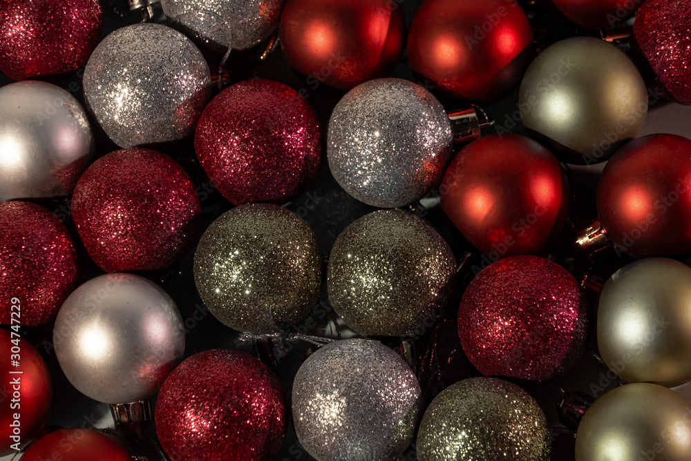 Multi-colored balls on a dark and blue background. Red, blue, purple, silver, gold Christmas toys Multi-colored balls on a dark and blue background. Red, blue, purple, silver, gold Christmas toys