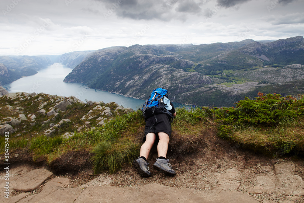 Hiker with a Backpack in Preikestolen (Norway) Hiker with a Backpack in Preikestolen (Norway)