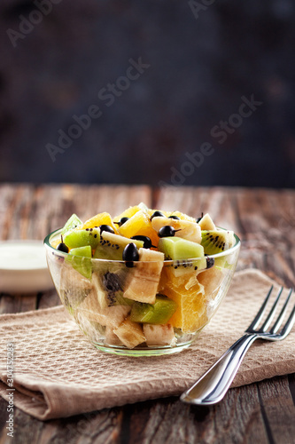 Fresh fruit salad for a healthy diet on wooden background