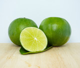 set of green fresh limes slice isolated on chopping block