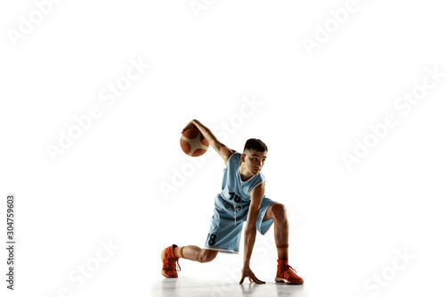 Full length portrait of young basketball player with a ball isolated on white studio background. Teenager training and practicing in action, motion. Concept of sport, movement, healthy lifestyle, ad.