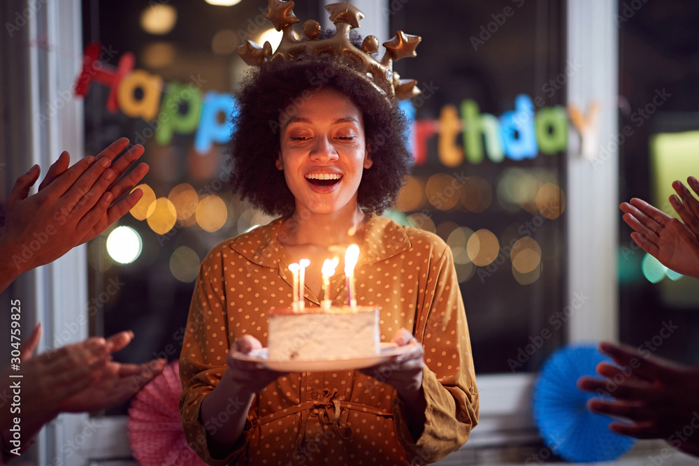 woman blowing out her birthday candles and celebrating Birthday - obrazy, fototapety, plakaty 