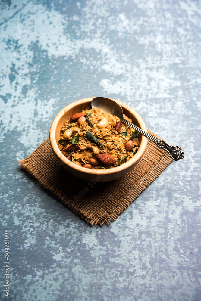 Fototapeta premium Oats Chivda / Chiwda is a healthy indian recipe with added chilli, peanuts, cashew, almond and curry leaf for flavour. Selective focus