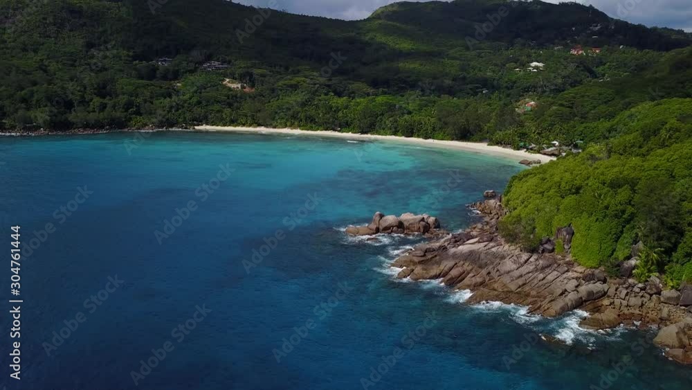 Seychelles view from seaside to the island Takamaka beach with rocks, waves and super white clean sand 4K footage Seychelles view from seaside to the island Takamaka beach with rocks, waves and super white clean sand 4K footage