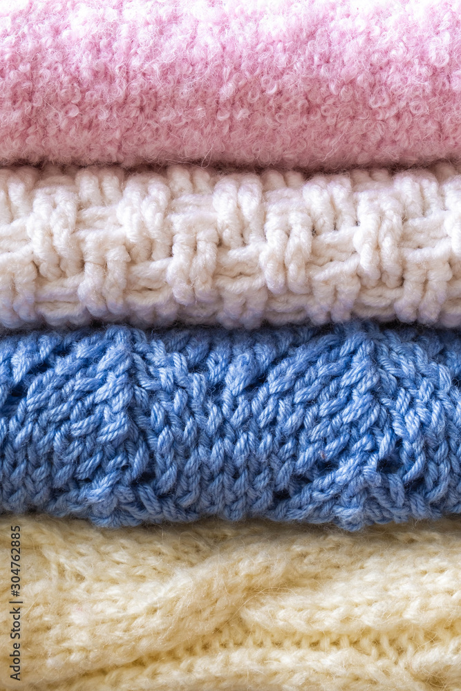 Hand knitted sweaters and blankets in pastel colors Hand knitted sweaters and blankets in pastel colors