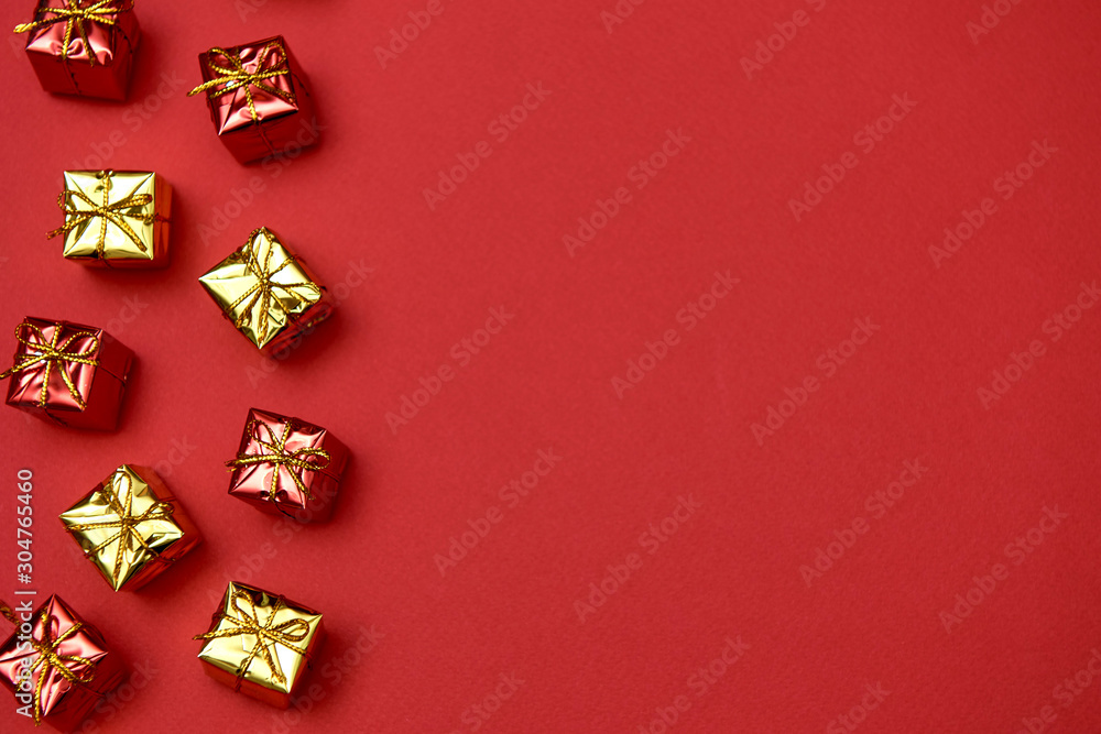 Creative Christmas pattern with yelloe and red gifts on red background, copy space. Minimal, winter, new year concept. Top view, flat lay