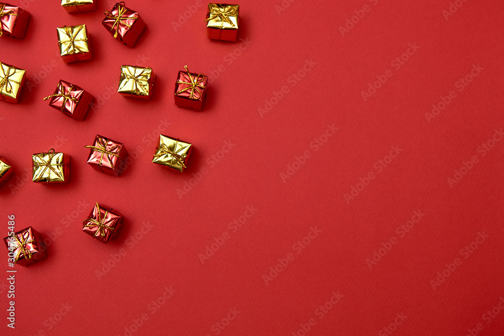 Creative Christmas pattern with yelloe and red gifts on red background, copy space. Minimal, winter, new year concept. Top view, flat lay