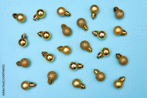 Wallpaper Mural Creative Christmas pattern with golden shiny baubles on blue pastel background, copy space. Minimal, winter, new year concept. Top view, flat lay Torontodigital.ca