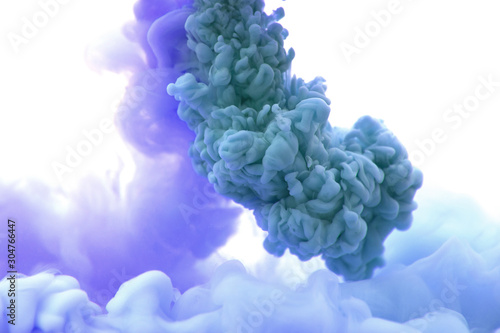 Abstract flowing liquid or blue ink in water on a white background. It looks like smoke or cloud. Or zero gravity.