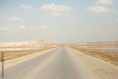 A beautiful photograph of a road in an open area.