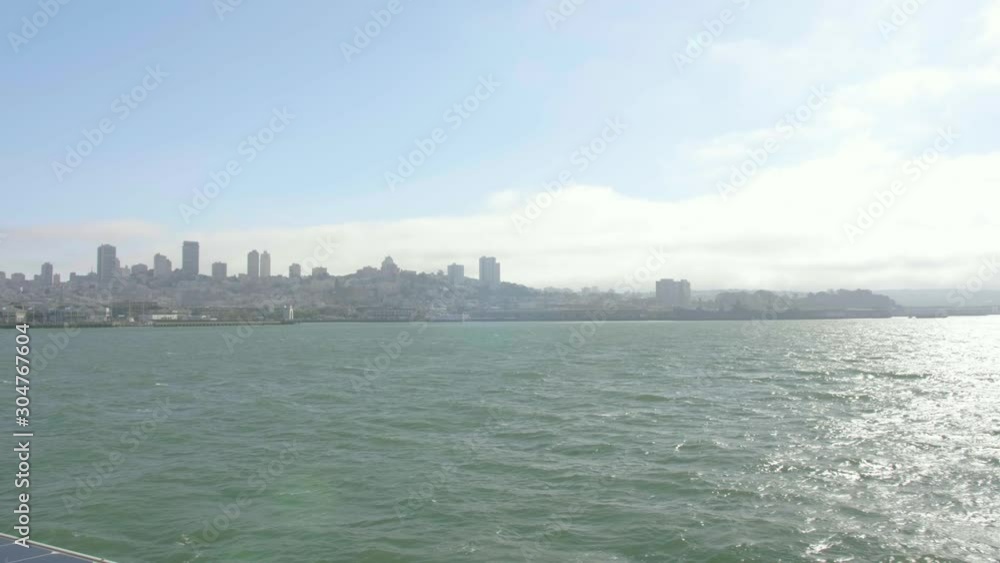View of San Francisco skyline from the ship approaching the dock returning from Alcatraz island, California USA. San Francisco bay with blue sky in a sunny day. View of San Francisco skyline from the ship approaching the dock returning from Alcatraz island, California USA. San Francisco bay with blue sky in a sunny day.
