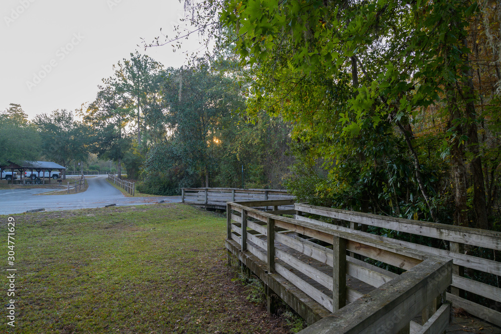 Fototapeta premium Picnic Tables in a Public Park with a Boardwalk to the River
