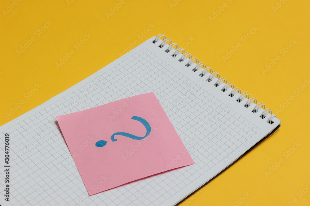 Notepad and memo piece of paper with question mark on yellow background. Notepad and memo piece of paper with question mark on yellow background.