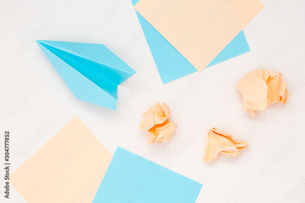 Business idea concept. Stickers, paper crumpled balls and airplane brainstorming symbols. Business idea concept. Stickers, paper crumpled balls and airplane brainstorming symbols.