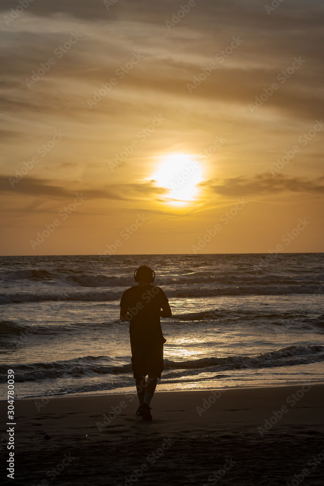 silhouette of a man on the beach at sunset