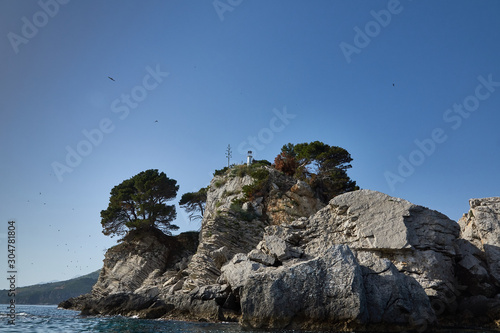 Small stone Islands in the sea with a lighthouse.