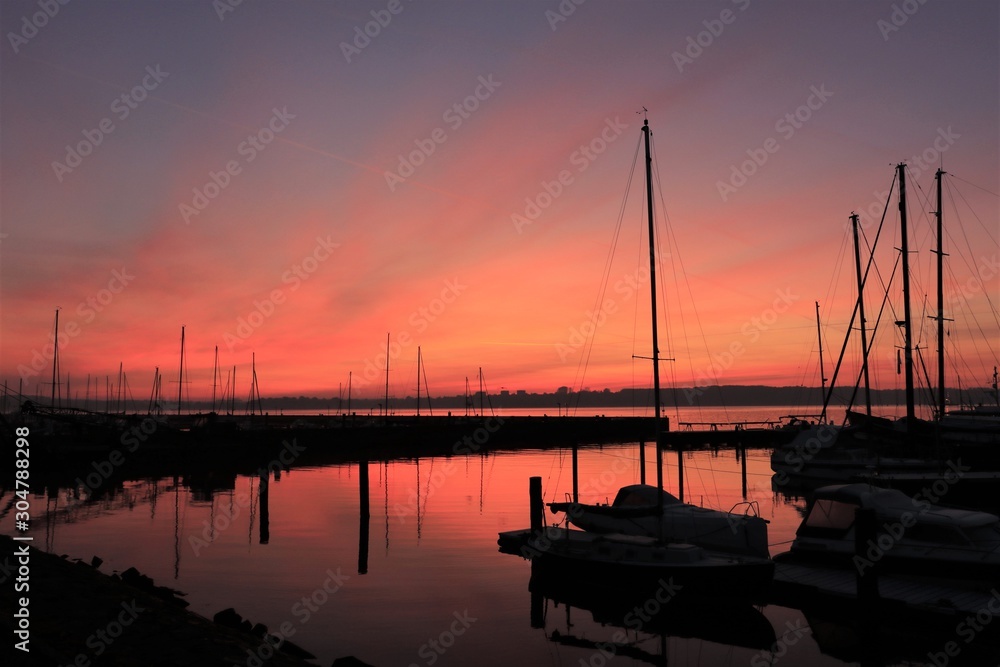 tranquil sea atmoasphere with red sky and sail boats