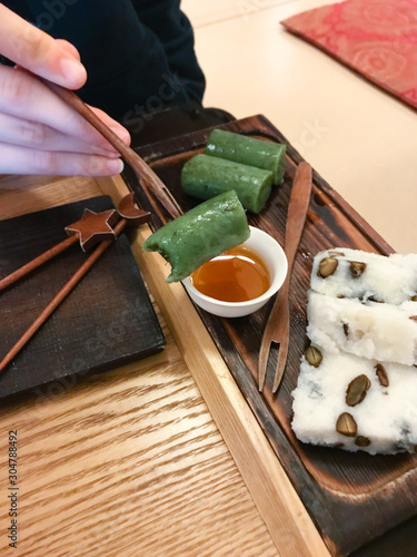 Photography eating sweet tteok (korean rice cake) in teahouse