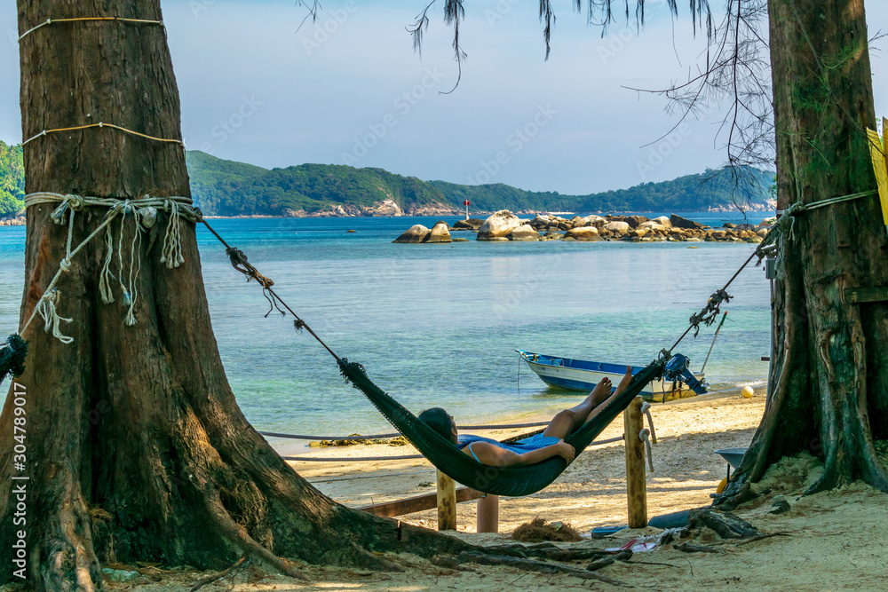 The Barat Perhentian, Besur, Perhentian Islands, Malaysia; 19-May-2019; a woman relaxing on hammock, The Barat Perhentian, Perhentian Islands, Malaysia
