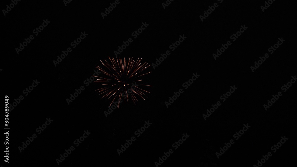 glowing fireworks show. colored night explosions in black sky. beautiful multi colored fireworks in night sky. New year's eve fireworks celebration. shining fireworks with bokeh lights in night sky.