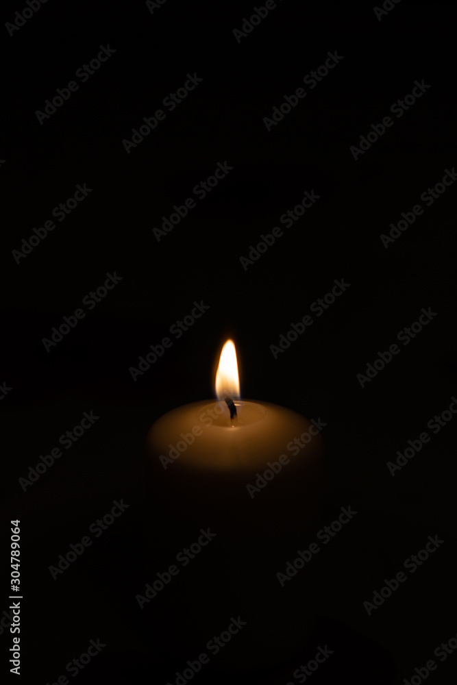 Candle on black background. Candle lighting in the room. Candle on black background. Candle lighting in the room.