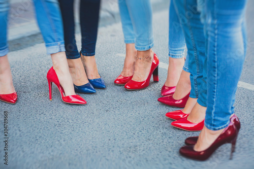 Row line of a legs on high heels in jeans pants during bachelorette party or a birthday, a group of bridesmaids having fun © tsuguliev