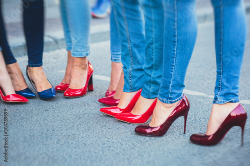 Row line of a legs on high heels in jeans pants during bachelorette party or a birthday  a group of bridesmaids having fun