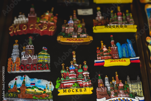 View of traditional souvenirs from Moscow, Russia, with fridge magnets with "Moscow" text, Kremlin and St. Basil Cathedral figure at local vendor souvenir shop on Red Square