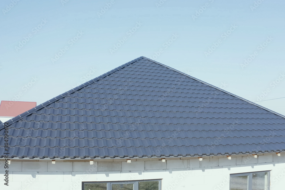 Fototapeta premium Corrugated metal roof and metal roofing. Modern roof made of met