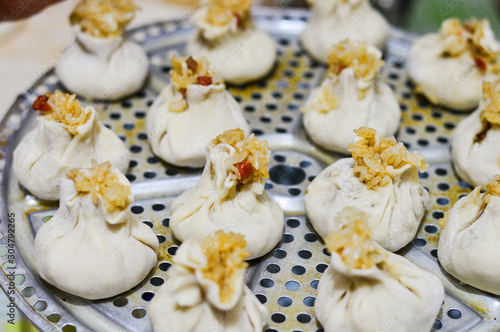 Chinese Shaomai (Rice Dumpling) Placed on Steamer Plate. Traditional Chinese Food. Chinese Home Cooking Scene. Chinese Shaomai (Rice Dumpling) Placed on Steamer Plate. Traditional Chinese Food. Chinese Home Cooking Scene.