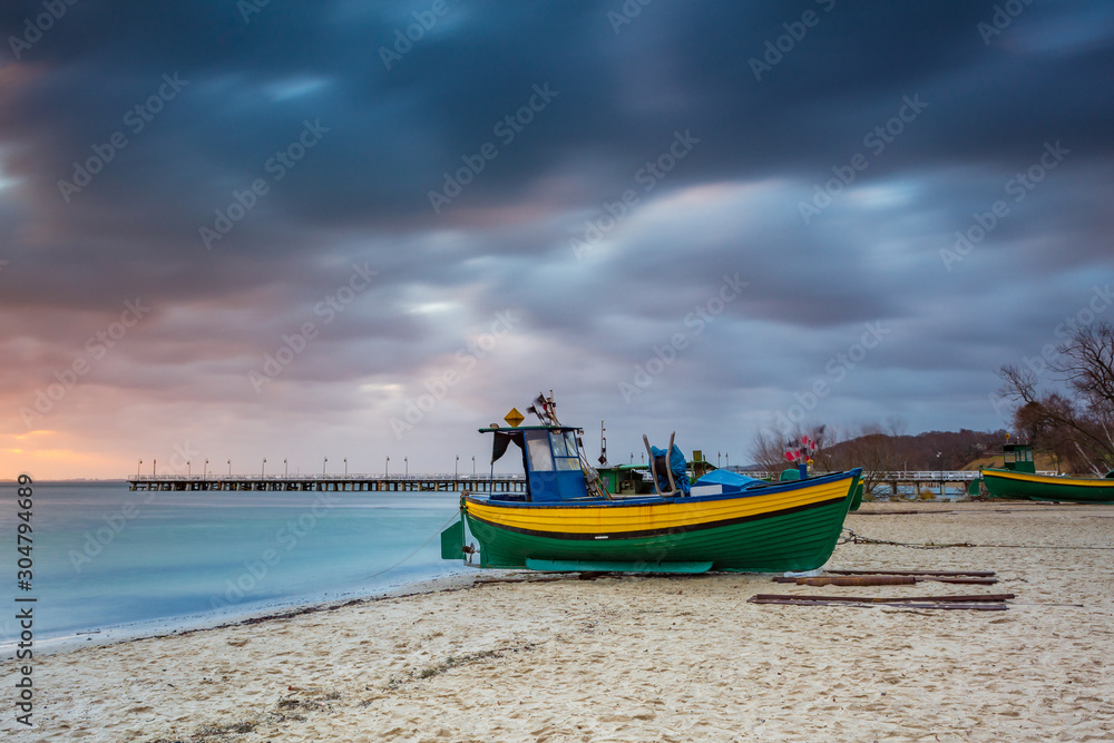 Fishing boats on the beach during sunrise in Gdynia. Baltic Sea. Poland