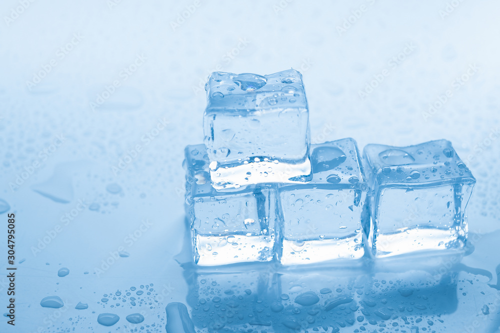 Ice cubes square with drops water clean on blue background Ice cubes square with drops water clean on blue background
