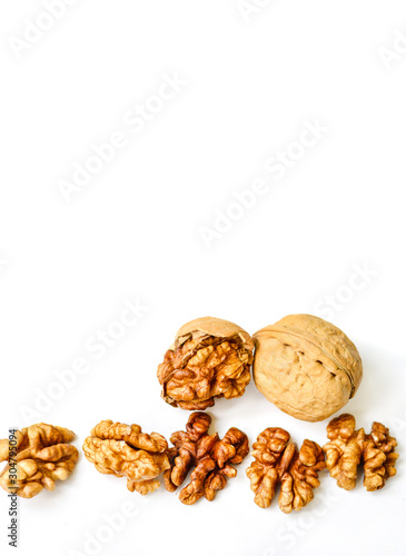 Walnut kernels and whole walnut isolated on white background. Copy Space. Close up. Healthy eating concept.