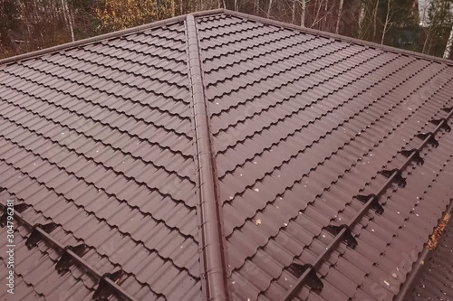 House with a brown metal roof.Corrugated metal roof and metal ro photo