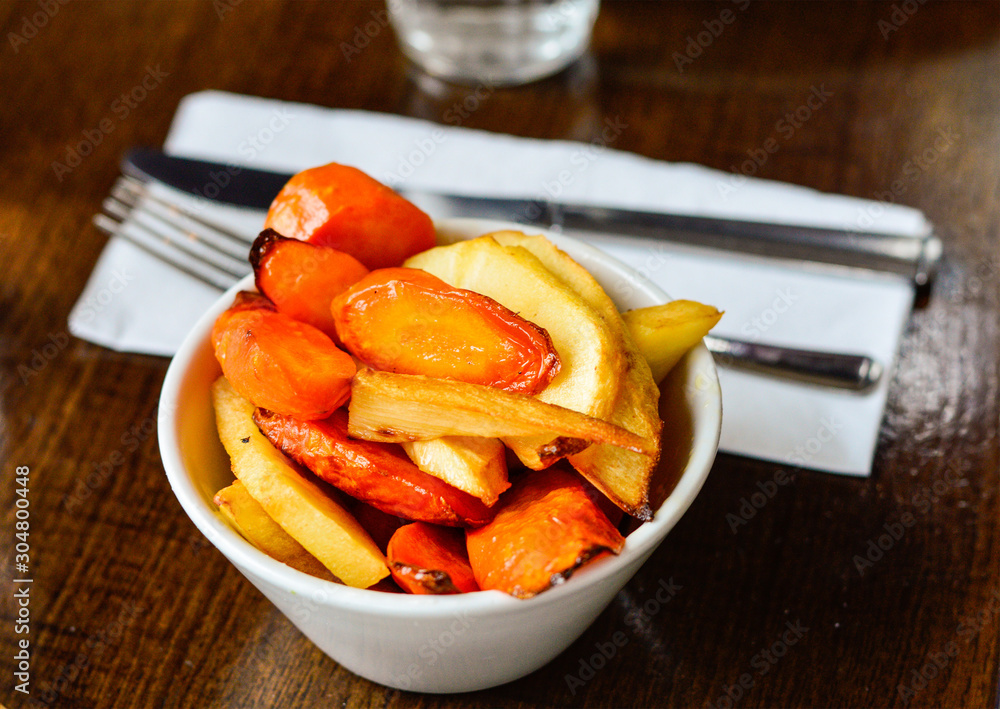 Roasted Carrots and Parsnips in a Bowl Placed at Restaurant Table