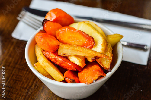 Roasted Carrots and Parsnips in a Bowl Placed at Restaurant Table