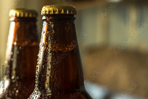cold beer bottle in droplets of water of their refrigerator