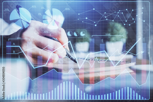 Financial forex charts displayed on woman's hand taking notes background. Concept of research. Double exposure