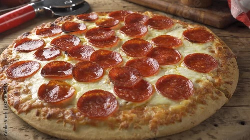 A slice of cheesy pepperoni pizza being served.