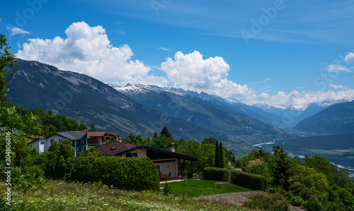 Wallpaper Mural Stunning alpine panorama colorful summer view. Beautiful outdoor scene Switzerland, Europe. Hazy blue mountains. Alpine houses, meadows on the slopes and snow-capped mountains. Torontodigital.ca