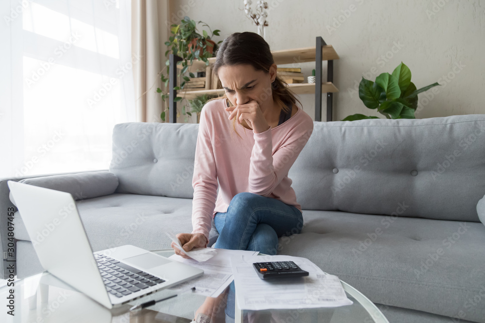 Pensive woman thinking managing family utility bills Pensive woman thinking managing family utility bills