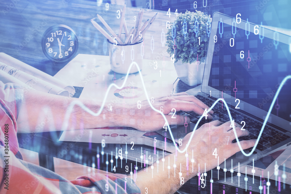 Double exposure of stock graph with businessman typing on computer in office on background. Concept of hard work. Double exposure of stock graph with businessman typing on computer in office on background. Concept of hard work.